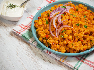 Bulgur wheat pilaf with chickpeas and vegetables.
