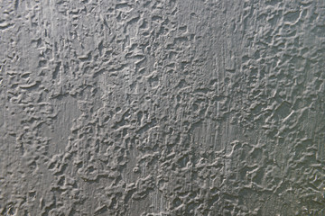 old gray painted surface with bumps and mounds