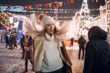 Portrait of a young smiling European woman. Walk on New Year's Moscow.