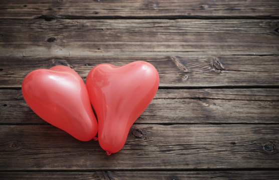 heart shaped red  balloons on  wooden background