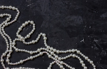 white pearl beads on black background,
