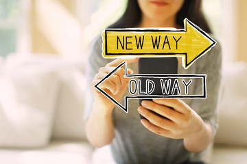 Old way or new way with woman using her smartphone in a living room