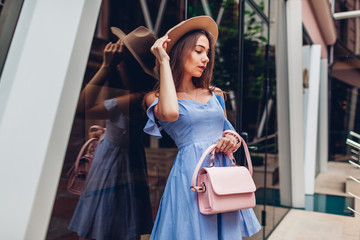 Outdoor portrait of young beautiful fashionable woman wearing stylish accessories. City fashion