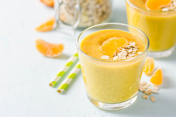 Tangerine turmeric smoothie. Selective focus, space for text.