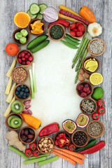 Health food concept for fitness background border with fresh fruit, vegetables, grains, nuts, seeds, coffee, herbs and spices. High in antioxidants, anthocyanins, vitamins and dietary fibre. 