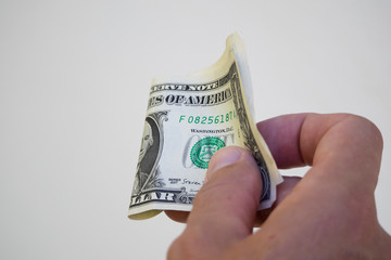 dollar in a man&rsquo;s hand.