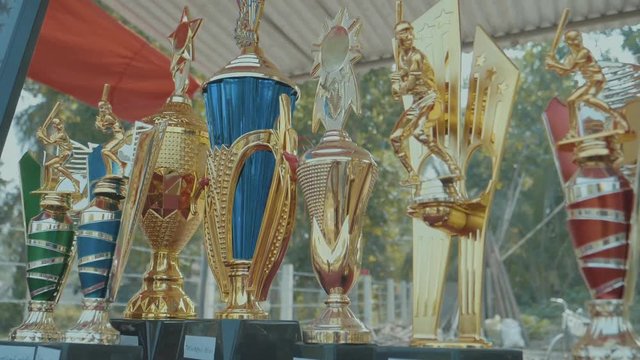 Group of impressive colorful cricket trophies in a display cabinet outside at a sporting ground in Sri Lanka showing off the great achievements of players
