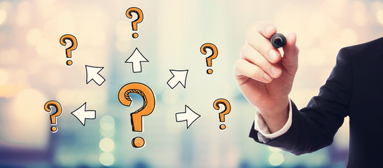 Big and small question marks with arrows with businessman on blurred abstract background