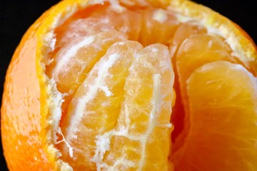 Mandarin Orange close up partially peeled