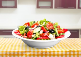 Close-up photo of fresh salad with vegetables in white plate