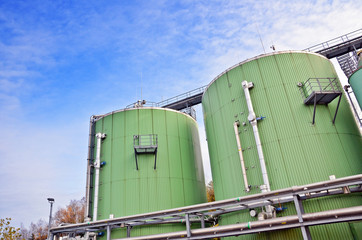 Biogas tanks on a biogas plant. Wastes recycling ecology concept. Green economics.
