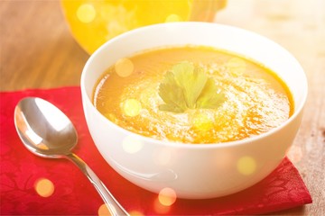Tasty Pumpkin or  carrot soup on background