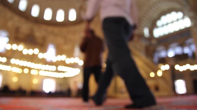 inside a mosque with people in bright lights