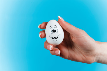 Hand. Egg with face