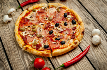 Tasty pizza on wooden background
