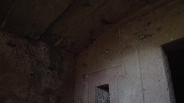 Interior views around stone walled tombs Etruscan burial site. Carved stone structure.