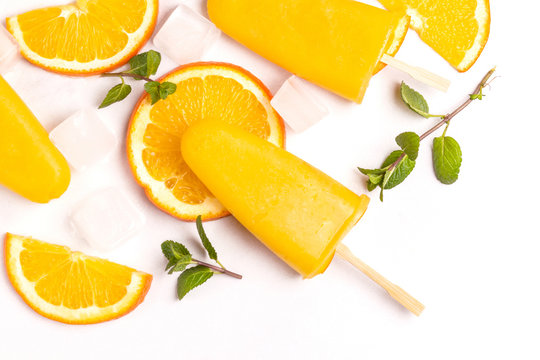 Homemade Orange Popsicle With Ripe Orange And Fresh Mint