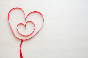 Two red ribbons shaped as heart. Heart in heart