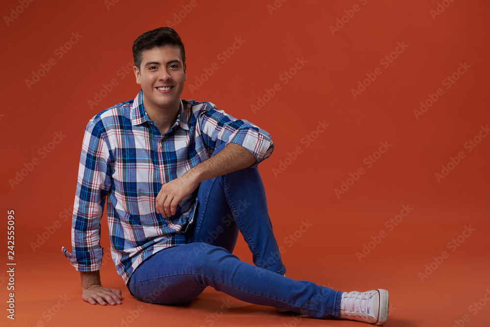 Wall mural young man sit on floor