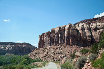 Street underneath big rocks in southwest America