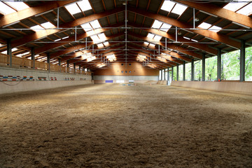 Panoramic view of an empty indoor horse riding arena