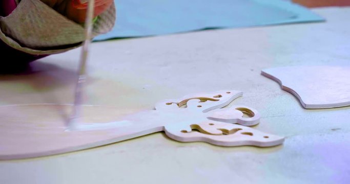 Christmas angel handcrafted art peice being painted with a brush with perfect strokes on a blank canvas
(close up shot)