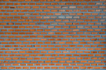 Red brick wall fragment background or brick layer building texture.