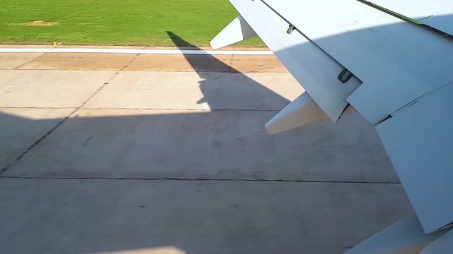The plane comes in to land at the airport, the landing of the aircraft view from the illuminator