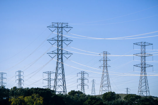 High voltage electricity towers on a blue sky background, California