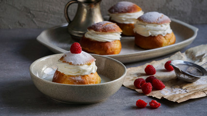 Semla or semlor, vastlakukkel, laskiaispulla is a traditional sweet roll made in various forms in...