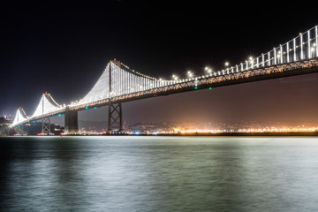 The illuminated Bay Bridge connecting San Francisco and Oakland via Treasure island on a clear...