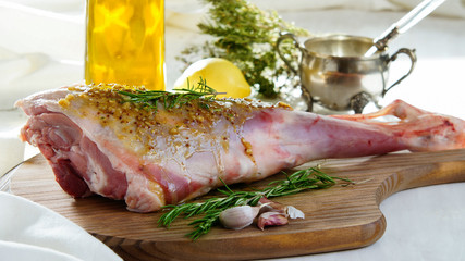 lamb leg raw with olive oil and mustard seeds marinade