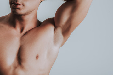 Close up of man showing his armpit while putting arm up - obrazy, fototapety, plakaty