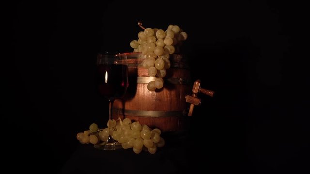 More accurate backward rotating wine barrel with grape and glass of wine.