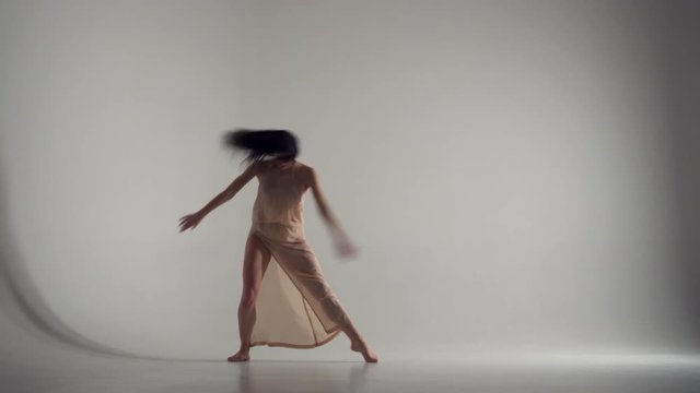 Beautiful woman freestyle dancing in studio