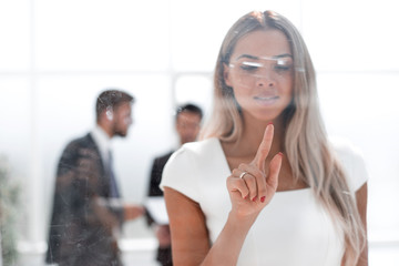young businesswoman pushing on glass Board.