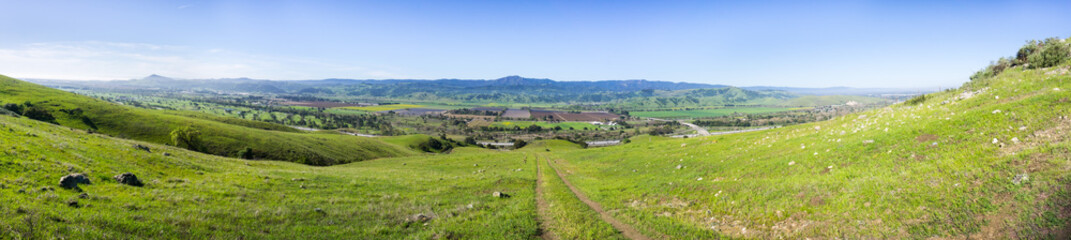 Trail through the verdant hills of south San Francisco bay area, panoramic view towards Coyote...