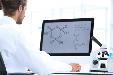 research scientist using computer chemistry laboratory