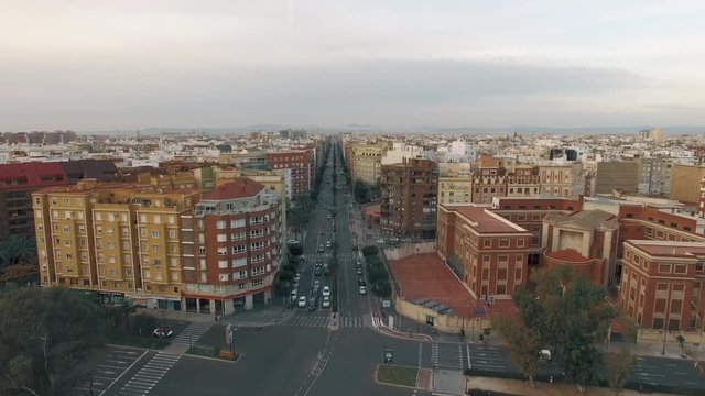 Aerial shot of Valencia, Spain. City buildings on Peris i Valero and Jacinto Benavente streets with car traffic. Winter view