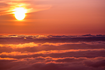 Bright sunlight reflected on a sea of clouds before sunset