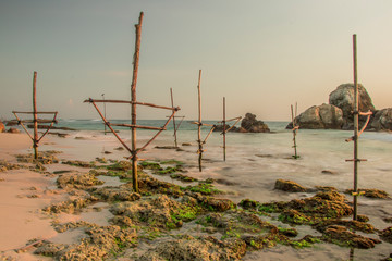 Long Exposure photography of Koggala Beach Sri Lanka with Coral Reefs and Fisherman Sticks