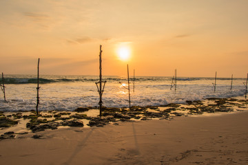 Sunset under Koggala Beach Sri Lanka with Fisherman Sticks on the background