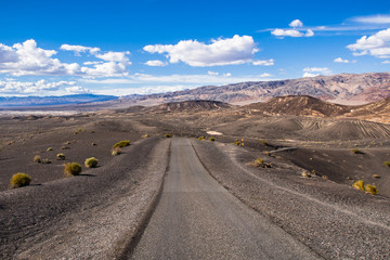 Travelling on an unpaved road through a remote area of Death Valley National Park; Ubehebe crater area in the background; California