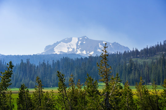 Smoke carried by the wind from the nearby wildfires covering Lassen Volcanic National Park; Lassen Peak visible in the background, Northern California