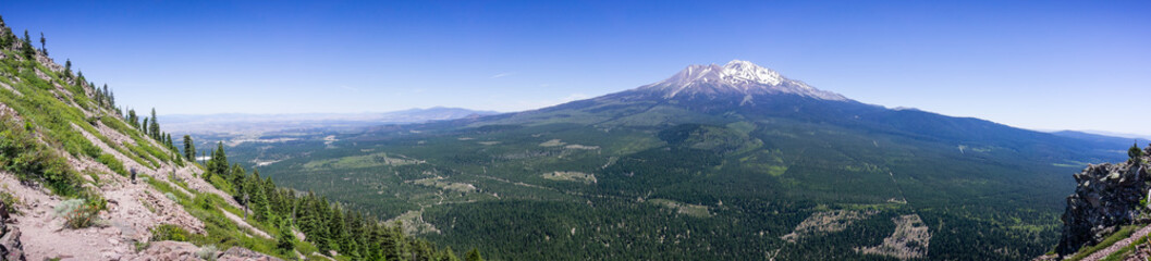 Fototapeta na wymiar Panoramic view of the hiking trail to Black Butte's top and the forests and summit of Shasta mountain covered in snow; Siskiyou County, Northern California