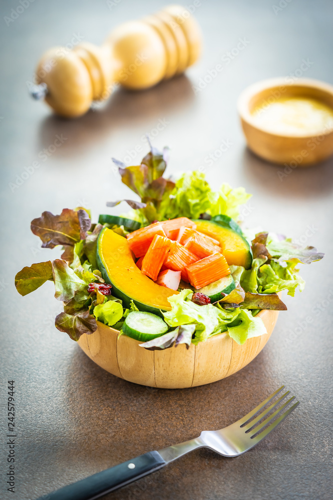 Wall mural Crab sticks meat with fresh vegetable salad with mayonnaise sauce