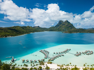 Aerial image from a drone of blue lagoon and Otemanu mountain at Bora Bora island, Tahiti, French...