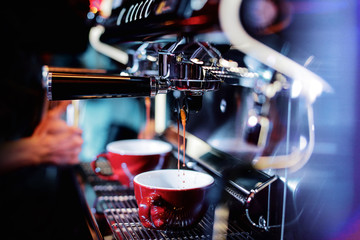 Fototapeta na wymiar espresso shot from coffee machine in coffee shop,Coffee maker in coffee shop