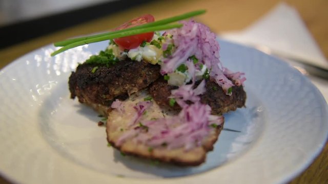 Danish smorrebrod open sandwich food - typical Danish Meatballs aka frikadeller. Traditional classic local Danish food from Copenhagen restaurant.
