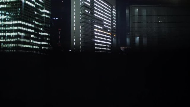 Modern city view from elevator in the night. Elevator goes up.